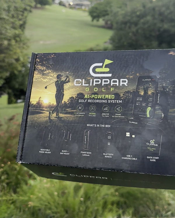 The Clippar golf recording kit in its printed box, held on a golf course