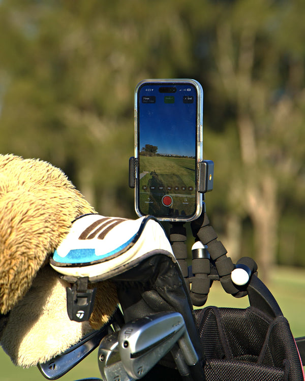 An iPhone in the Clippar holder on a golf bag at the range, recording