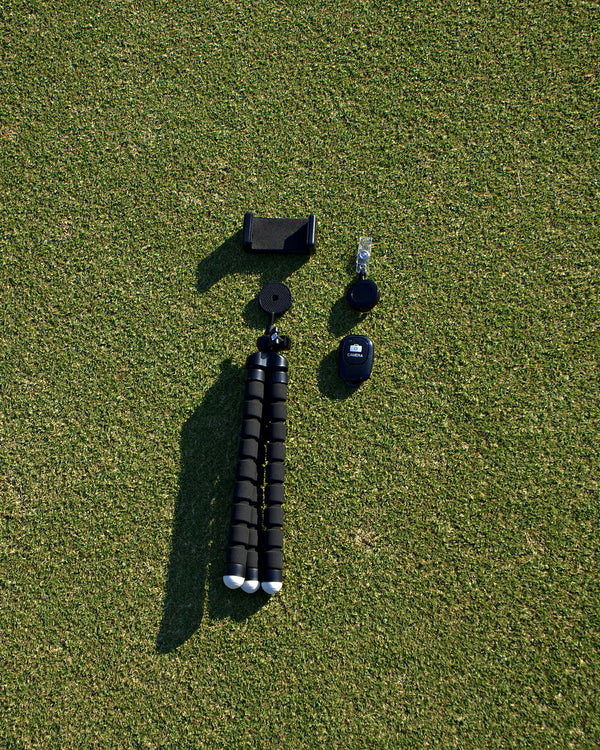 Everything in the Clippar golf recording kit laid out on grass