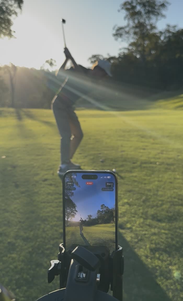 Phone in the Clippar mount filming a golf swing at golden hour